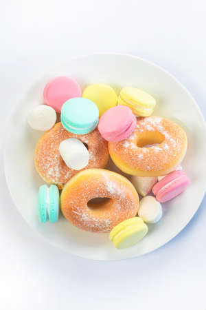 Different sweets isolated on white background, Doughnuts, macarons top view, unhealthy and candy conceptの写真素材