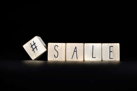 Hashtag and sale written on a black background with space for text. Concept of selling products online store, social media on Blackの写真素材