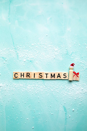 Santa Claus with the text Christmas and gift box with red bow on blue background with snow, Merry Christmas, Holiday,present concept with copy spaceの写真素材