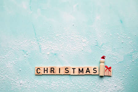 Santa Claus with the text Christmas and gift box with red bow on blue background with snow, Merry Christmas, Holiday,present concept with copy spaceの写真素材