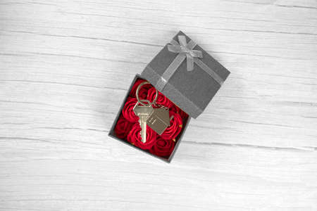 Silver new keys in golden sparkling gift box for buying new house, present, real estate concept top...