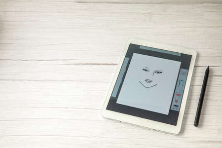 Digital creative artist tablet with pen for drawing, modern art technology concept on wooden office desk, copy space top view space for textの写真素材