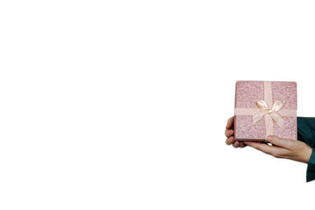 Holiday gift. Happy birthday. Greeting congrats. Party celebration. Advertising background. Elegant female hand holding present box isolated white copy space.の写真素材