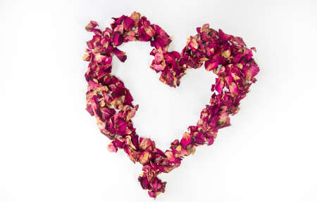 beautiful heart of dried red rose petals isolated on white background, copy space, Valentines Day...
