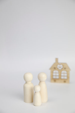 Happy family with there new house. Isolated on white background, wooden object with copy space, real estate, mortgage,property conceptの写真素材