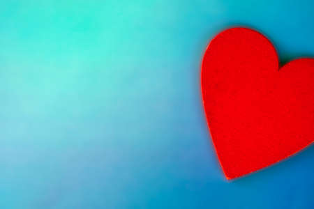 Soft pink heart on a light blue background close-up. Greeting card with copy space. Flat lay minimal concept. Valentines Day backgroundの写真素材