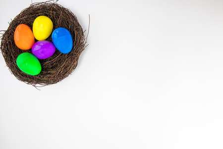 Colorful painted Easter Eggs isolated on white background with nest.Top view Happy Easter Holiday...
