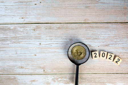 Cryptocurrency in 2022 price value prediction, forecast concept. Golden crypto coins Bitcoin,...