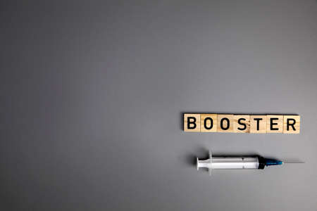 booster shots vaccine text on Gray background  booster shots, with syringe top view and copy space , medical health,pandemic and vaccine concept.の写真素材