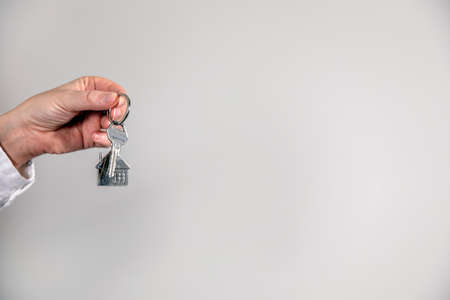 Real estate agent with house model and keys, selling house,property owner mortgage concept with copy...