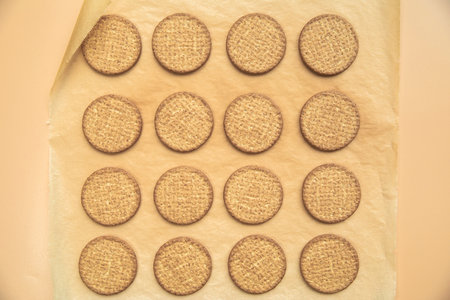 Freshly baked homemade sesame seed cookies on wooden board, rustic table. Healthy, tasty snack,...