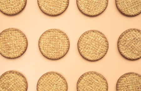 Freshly baked homemade sesame seed cookies on wooden board, rustic table. Healthy, tasty snack,...