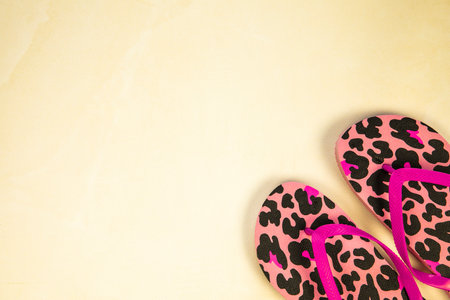 Summer concept. Beach and flip flops on yellow and sand color background. flat lay. Minimal style. copy-space. Top view. close-upの写真素材