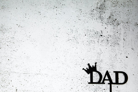 Happy Fathers Day concept. Black Letters with text Happy Father's Day on concrete white black background Flat lay, top view, copy space king crownの写真素材