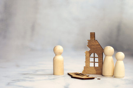 Divorce, division of property, poverty and no money concept. Wooden broken house on light background. Mortgage, rent, realtor concept copy space space for text broken homeの写真素材