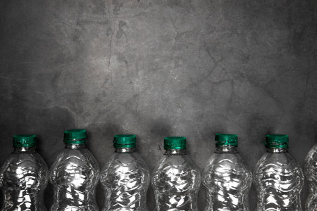 Recycling and ecology concept. Sorting household waste captured from above, flat lay. Grey concrete background empty plastic bottles copy spaceの写真素材