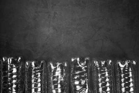 Recycling and ecology concept. Sorting household waste captured from above, flat lay. Grey concrete background empty plastic bottles copy spaceの写真素材