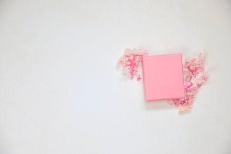 Open and closed pink gift box place for product on bright background with flowers .Flat lay, top view, mock-up gift,present Mothers Day,Valentines Day,Birthday concept copy spaceの写真素材