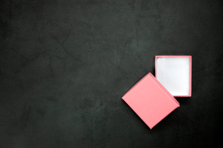 Pink open or closed gift box on a gray concrete background. Top view. copy-space. present,Birthday,Mothers Day,Valentines Day concept space for textの写真素材