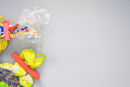 Food bag clips for keeping food fresh,plastic bag clips or Sealer on plastic bags are isolated on a gray background. Copy space, top view packagingの写真素材