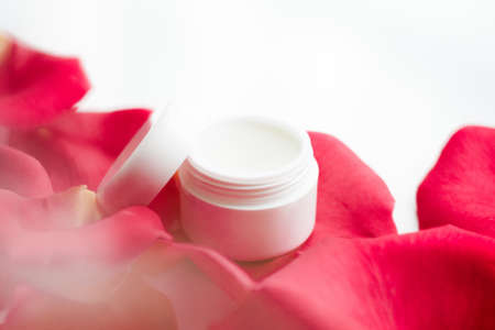 beauty cream jar and rose petals - cosmetics with flowers styled concept