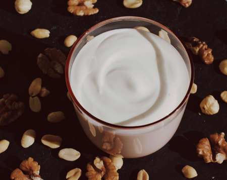 dairy and rustic farm food styled concept - fresh yogurt and nuts, elegant visualsの写真素材