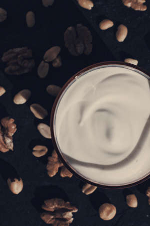 dairy and rustic farm food styled concept - fresh yogurt and nuts, elegant visualsの写真素材