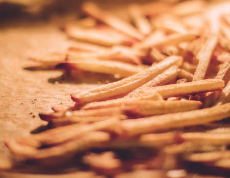 just cooked french fries in the oven - rustic food and homemade cooking styled concept, elegant...