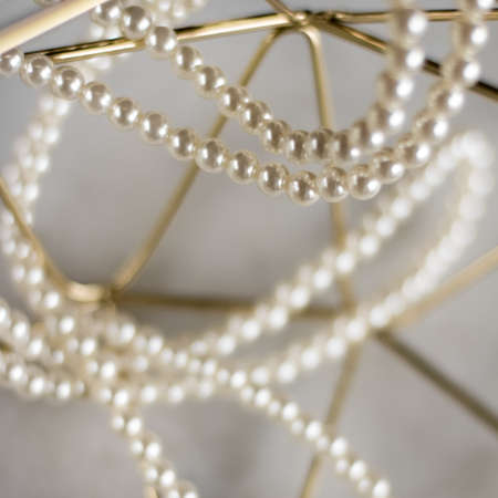 Pearl necklace on golden marble, ethical jewellery - luxury background, jewelry as a gift concept. Pearls are girl's best friendsの写真素材
