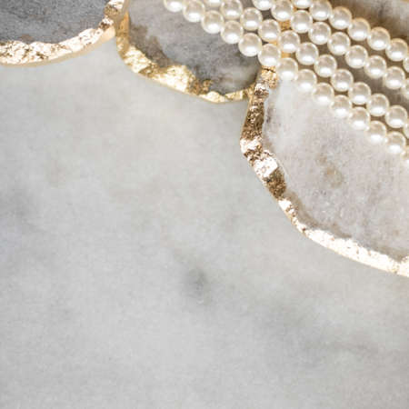 Pearl necklace on golden marble, ethical jewellery - luxury background, jewelry as a gift concept. Pearls are girl's best friendsの写真素材