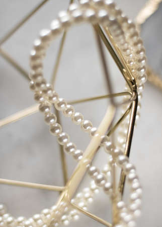 Pearl necklace on golden marble, ethical jewellery - luxury background, jewelry as a gift concept. Pearls are girl's best friendsの写真素材