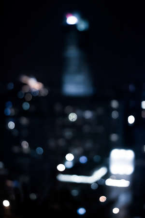 Blurry metropolitan district - night life, abstract background and modern dark tones concept. Big city comes alive at nightの写真素材