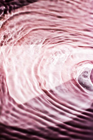 Pink flowing water texture as an abstract background - colourful liquids and creative designs concept. Pink flowの写真素材