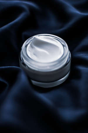 Beauty, anti-age cosmetics and skincare concept - Luxury face cream jar on a dark blue silkの写真素材