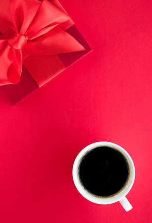 Romantic celebration, lifestyle and birthday present concept - Luxury beauty gift box and coffee on red, flatlayの写真素材