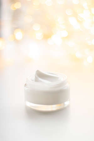 Beauty, anti-age cosmetics and skincare concept - Luxury face cream jar and holiday glitter