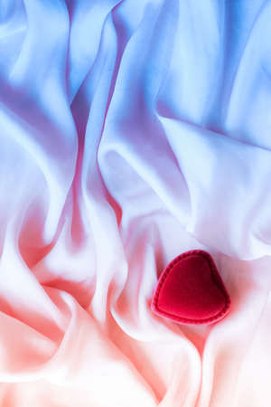 Valentine's day, true love, engagement and proposal concept - Heart-shaped gift box on neon silk. Will you be my Valentine?の写真素材