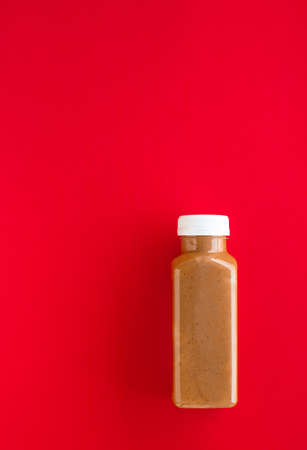 Detox, diet and healthy lifestyle concept - Chocolate banana smoothie bottle on red, flatlayの写真素材