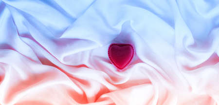 Valentine's day, true love, engagement and proposal concept - Heart-shaped gift box on neon silk. Will you be my Valentine?の写真素材