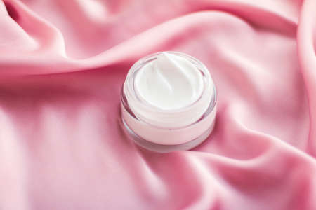 Beauty, anti-age cosmetics and skincare concept - Luxury face cream jar on a soft pink silkの写真素材