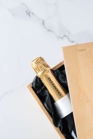 Wedding celebration, lifestyle and luxury present concept - A champagne bottle and a gift box on marbleの写真素材