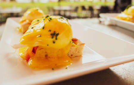 Restaurant service, food recipes and breakfast concept - Poached egg with salmon for brunch in a luxury restaurantの写真素材