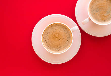Breakfast, drinks and modern lifestyle concept - Hot aromatic coffee on red background, flatlayの写真素材