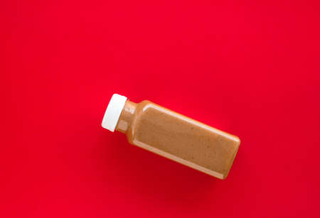 Detox, diet and healthy lifestyle concept - Chocolate banana smoothie bottle on red, flatlayの写真素材