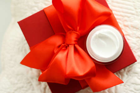Beauty, cosmetics and skincare styled concept - Luxury face cream jar and red gift box