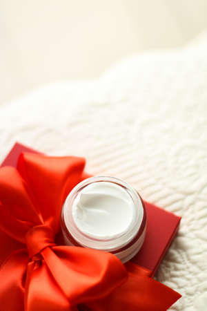 Beauty, cosmetics and skincare styled concept - Luxury face cream jar and red gift boxの写真素材