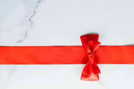 Holiday decor, feminine design and flatlay concept - Red silk ribbon on marble, top viewの写真素材