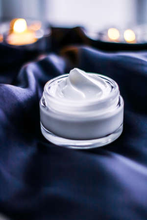 Beauty, anti-age cosmetics and skincare concept - Luxury face cream jar on a dark blue silkの写真素材