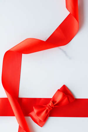 Holiday decor, feminine design and flatlay concept - Red silk ribbon on marble, top viewの写真素材
