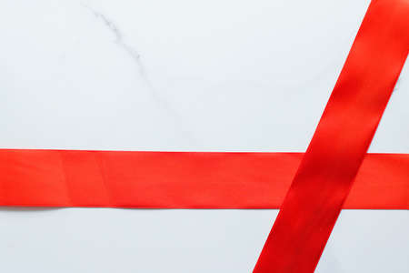 Holiday decor, feminine design and flatlay concept - Red silk ribbon on marble, top viewの写真素材